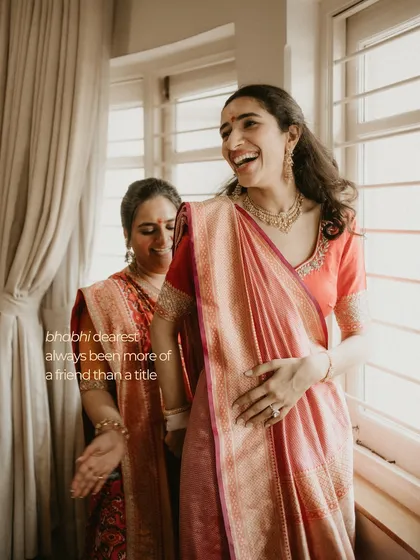 A bride sharing a laugh with her sister-in-law. Our 'GHAR' lookbook is filled with these candid moments that highlight the importance of family bonds and comfort over couture.