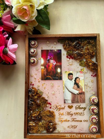 A unique design where I preserved not just the varmala flowers but also the decorative 'kalasha' elements from the wedding. This shows my ability to incorporate various meaningful items into a single frame.
