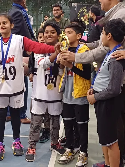 Pure joy on the faces of our U-10 players as they hold up their first-place trophy.