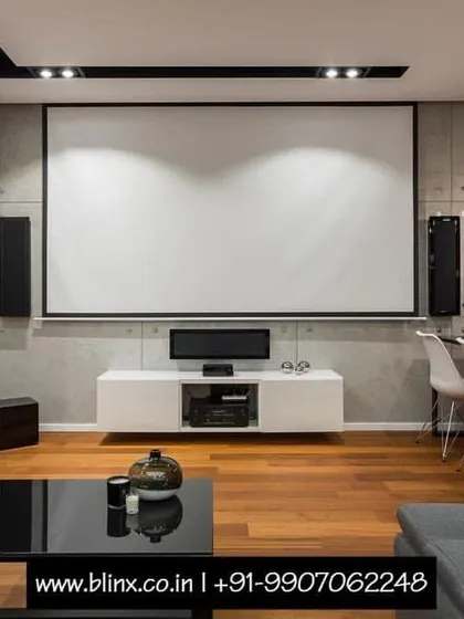 You don't need a dedicated room to have a spectacular home theater. Here, we integrated a full projection screen, console, and speaker system into a modern living and dining area. This setup proves that high-performance entertainment can coexist beautifully with contemporary interior design.