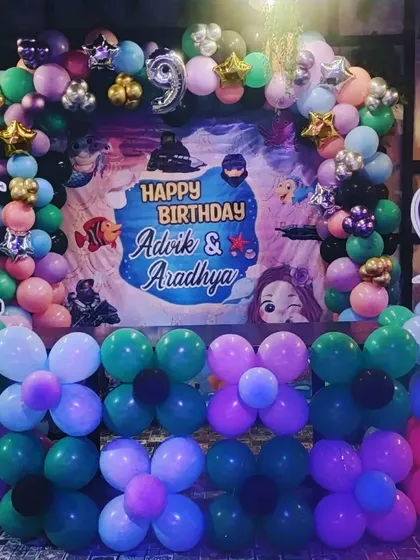 A unique dual-theme birthday party featuring Halo and The Little Mermaid, with a custom backdrop and character cutouts.