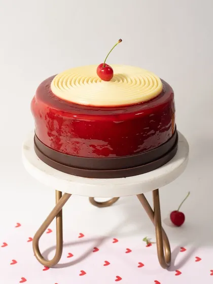 Another shot of the cherry mirror glaze cake, showcasing its flawless finish and vibrant color.