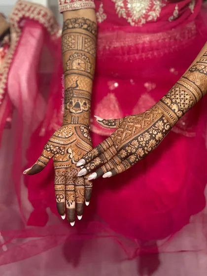 A beautiful bridal mehendi design with a mix of traditional Indian and modern elements. The artwork covers the hands and extends up the arms, perfect for a bride's special day.