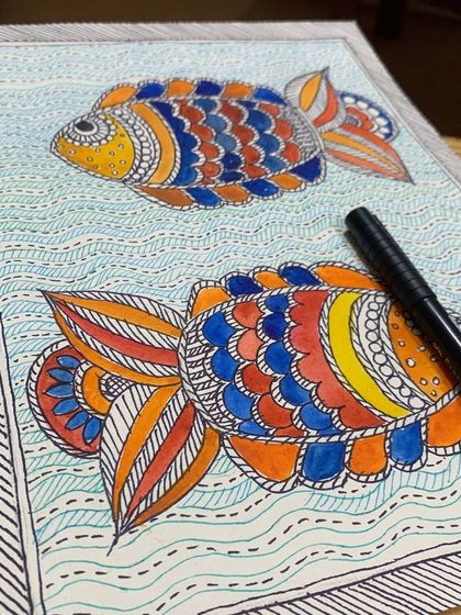 Can you guess which art form this is? A fun quiz featuring a student's beautiful Madhubani fish painting, filled with colorful, intricate patterns.