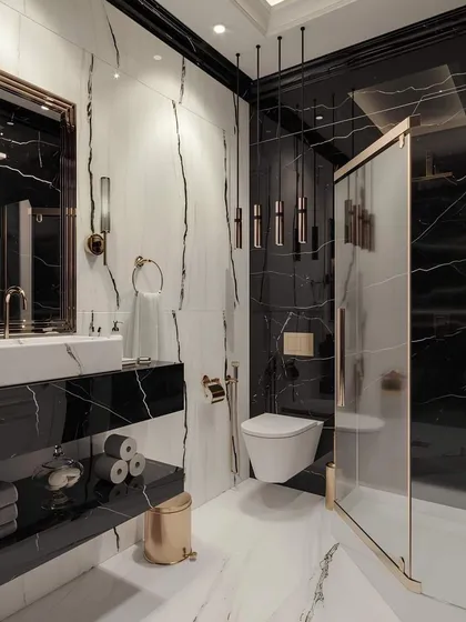I transform bathrooms into personal spas with bold materials and thoughtful layouts. This design uses dramatic black and white marble with gold fixtures, a floating toilet, and a glass shower enclosure for a clean, high-end finish.