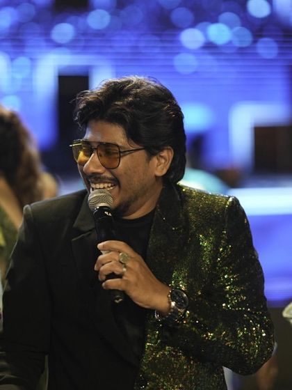 A candid shot of me interacting with the audience during a Sangeet. My style is to be approachable and engaging, making everyone feel part of the celebration.