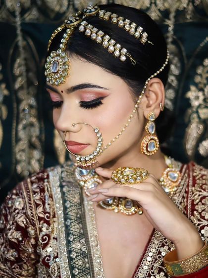 Another elegant pose, highlighting the detailed matha patti and the soft pink eyeshadow.