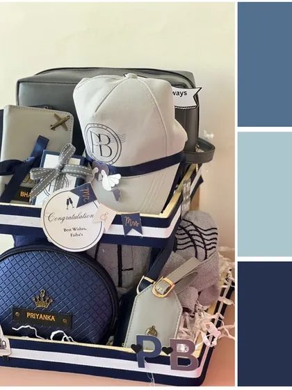 This tiered hamper in shades of blue is perfect for a couple who loves to travel. It includes personalized caps, pouches, and luggage tags for both him and her, all beautifully coordinated.