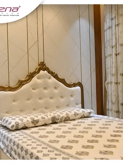 For this bedroom, we used a classic design with a tufted white headboard framed in ornate gold. The elegant wallpaper and matching curtains create a royal and luxurious atmosphere.