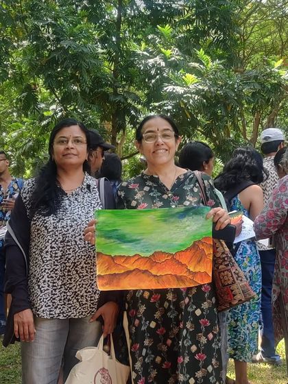 Another shot of us with a newly completed painting, full of vibrant colors.