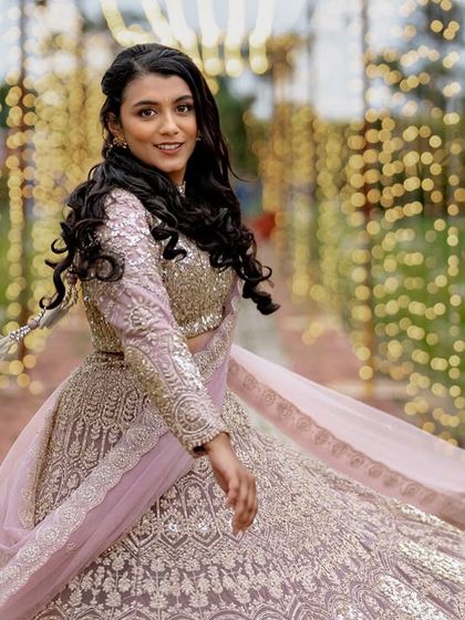 A beautiful shot of the bride-to-be twirling, with a tunnel of warm fairy lights creating a magical bokeh effect in the background. This is a perfect example of how lighting can transform a space.