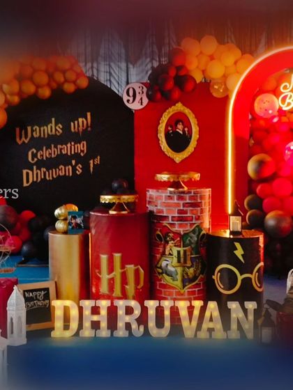 Another angle of the detailed Harry Potter dessert table and backdrop, showcasing the arrangement of themed props and personalized elements.