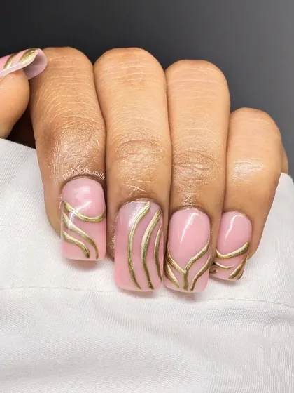 Metallic gold lines on a soft pink base. This design is simple, elegant, and so chic. The clean lines and geometric pattern give it a very modern feel.