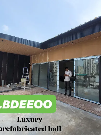 A luxury prefabricated hall on a terrace. This wide-angle shot showcases a large, open-plan structure perfect for gatherings, a home gym, or a creative studio.