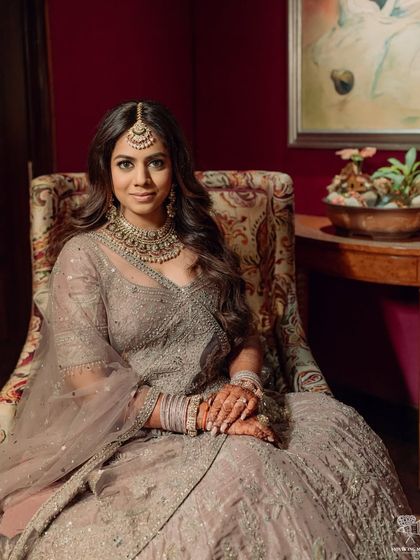 A beautiful wedding portrait of the bride in a lovely lavender-grey lehenga. The makeup is soft and romantic, with open hair for a modern feel.