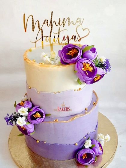 This purple and white floral cake is one of my most popular designs. The ombre watercolor effect and purple peonies create a breathtaking look every time. This no-fondant beauty was a chocolate sponge with a light strawberry compote filling.
