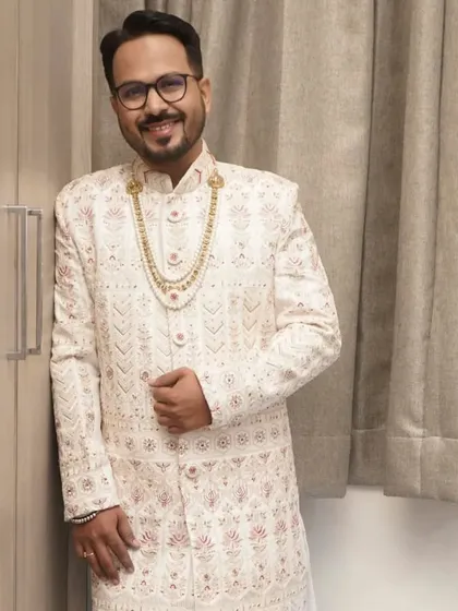 A full-length view of the groom's elegant wedding attire. My job is to ensure your grooming and makeup complete the look perfectly.