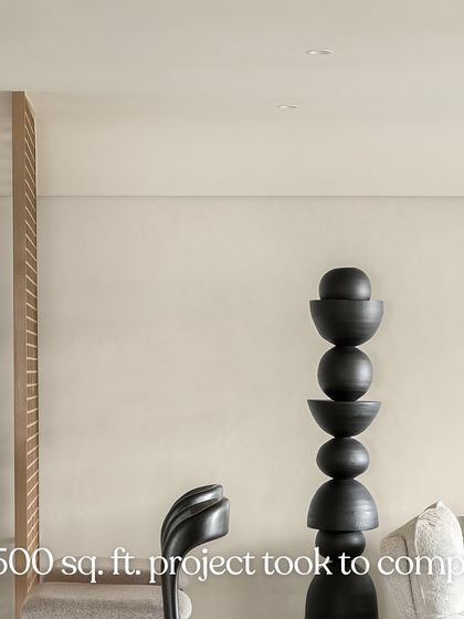 The calm you see is the result of months of planning. This image of the black totem sculpture in the living room hints at the complex design process behind the serene final product.