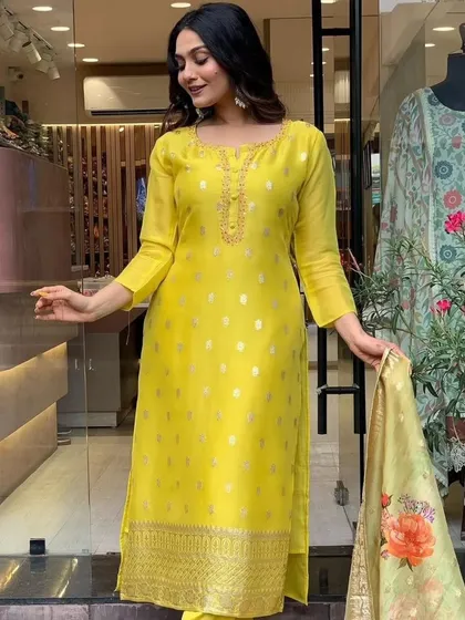 A mustard viscose organza kurta with jacquard woven details. The printed dupatta adds a modern touch to this traditional fabric.