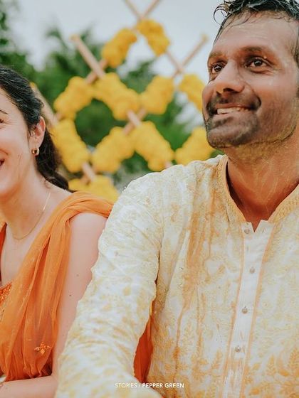 Eli and Suman sharing a laugh during their Haldi. The genuine happiness between the couple is the most important element to capture.