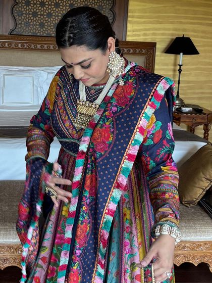 A candid moment showing the client adjusting her outfit, with her beautiful braided hair on display.