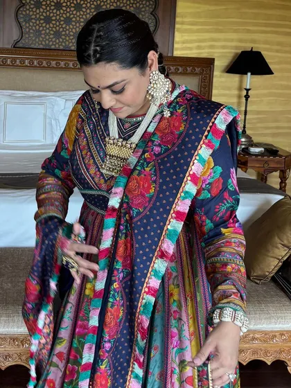 A candid moment showing the client adjusting her outfit, with her beautiful braided hair on display.