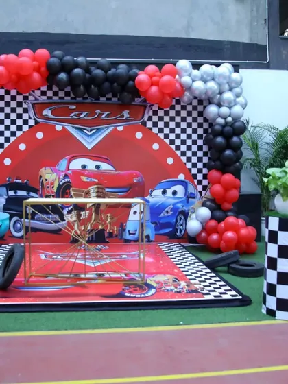 The main stage for our Cars party. A checkered flag backdrop, themed carpet, and character cutouts create the perfect spot for cake cutting and photos.