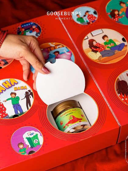 Another delightful surprise from the "Nok Jhok" box. Tearing open the perforated window reveals a jar of Raspberry Jam Mini Cookies, adding a layer of fun and discovery to the gifting experience.