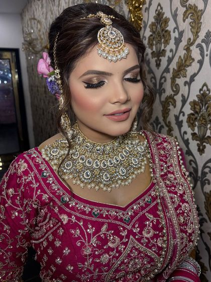 A close-up of the eye makeup. The blended gold and brown tones create a sophisticated and glamorous look that makes her eyes pop.