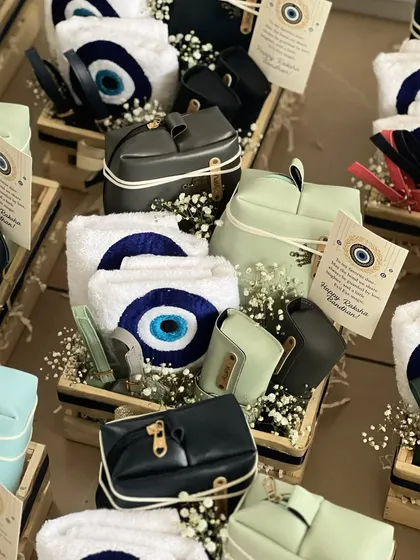 A beautiful display of our Evil Eye themed Rakhi hampers for bhai and bhabhi. Each crate contains personalized pouches and matching towels, making it a coordinated and thoughtful gift.