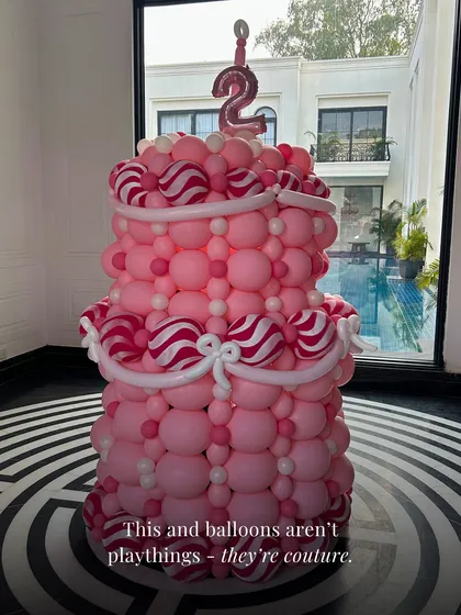 Balloons aren't playthings, they're couture. This close-up of our pink tiered cake sculpture shows the detailed work that goes into creating these high-fashion party pieces.