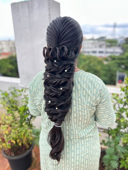 A final look at the artistic and modern sculptural braid, a testament to creative hairstyling.