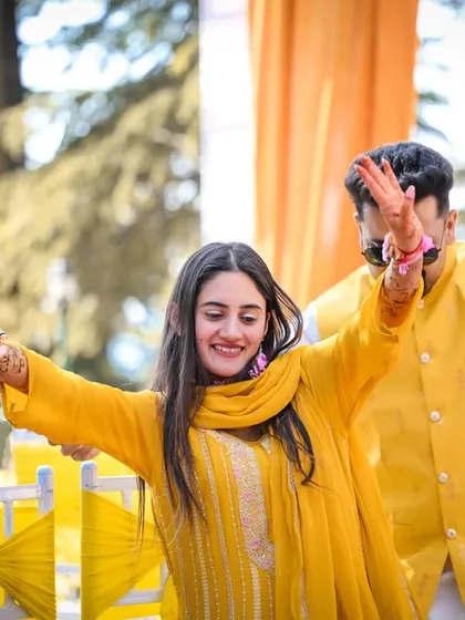 The couple dancing with full energy during their Haldi celebration. I focus on capturing the movement and joy of these moments.