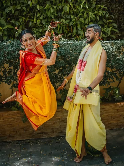 Who says traditional weddings can't be fun? We love capturing the couple's playful side, like this joyful jump, which shows their personalities shining through on their special day.