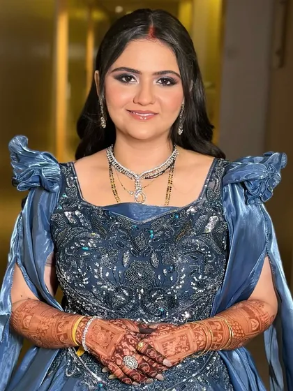 A beautiful portrait of the bride. Her soft glam makeup, featuring a defined eye and a neutral lip, perfectly complements her intricate blue gown.