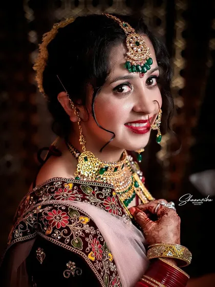 A classic close-up portrait of a smiling bride. I use lighting to highlight the beautiful makeup, jewelry, and the genuine happiness in her eyes.