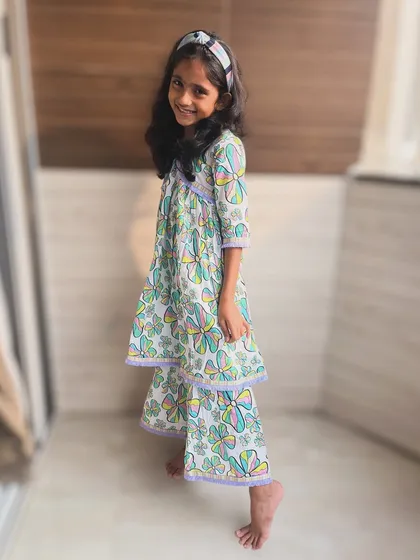 A playful take on the classic angarkha. This butterfly print set with tiered sharara pants is whimsical and fun, made from soft cotton for ultimate comfort.