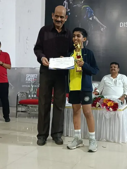 Kaavya Parmar accepting his gold medal trophy for the under-13 boys singles at the Yonex Sunrise BAMU District Badminton Championship.