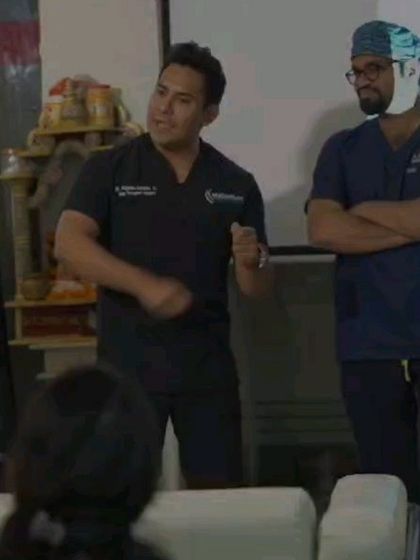 A moment of instruction during a training session. I focus on providing direct feedback and guidance to ensure each doctor masters the nuances of hair restoration surgery.