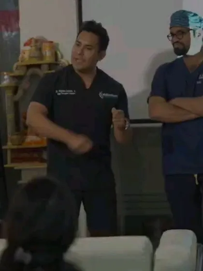 A moment of instruction during a training session. I focus on providing direct feedback and guidance to ensure each doctor masters the nuances of hair restoration surgery.