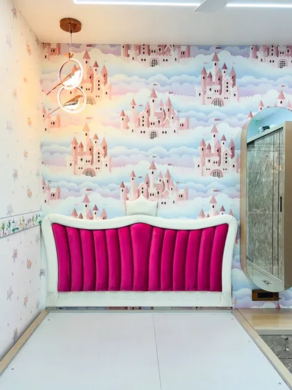 The bed in the princess room, showing the elegant scalloped headboard design and the attached floating dressing table.