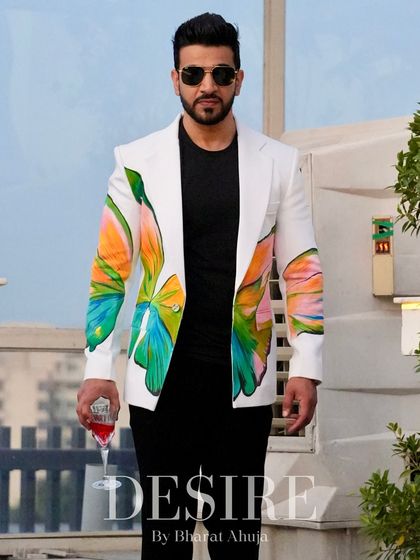 A powerful shot of the white blazer with its bold, colorful print. This is more than an outfit; it’s a statement of elegance and individuality.
