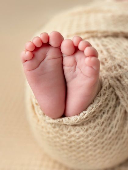 A macro shot of a newborn's tiny feet in black and white. These are the details that turn your world upside down in the best possible way.