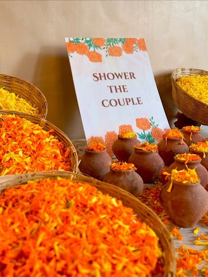 It's all in the details. We set up these adorable miniature clay pots and baskets filled with marigold petals for guests to shower the couple.