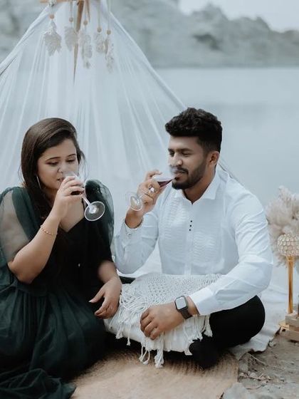 A romantic moment from a styled picnic shoot, with the couple sharing a glass of wine. These details help tell a more complete pre-wedding story.