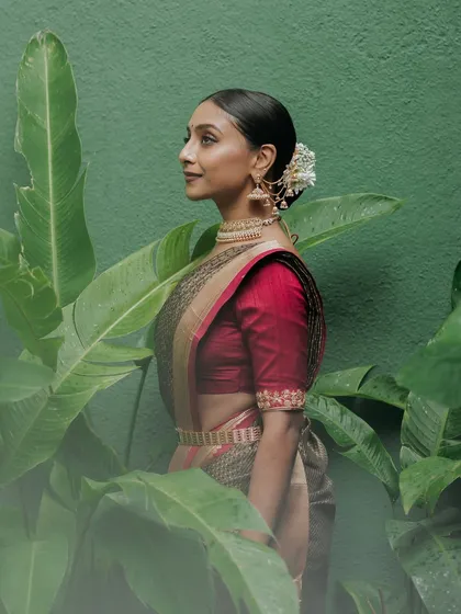 A bride framed by large, lush banana leaves, a shot that emphasizes the tropical, natural beauty of our gardens.