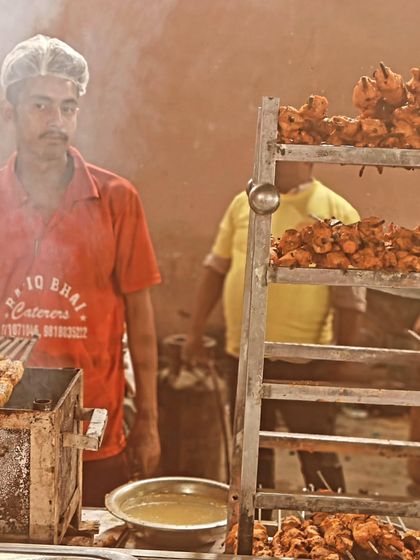 One of our skilled team members preparing fresh kebabs. We take pride in our work, ensuring every piece is cooked to perfection for your event.
