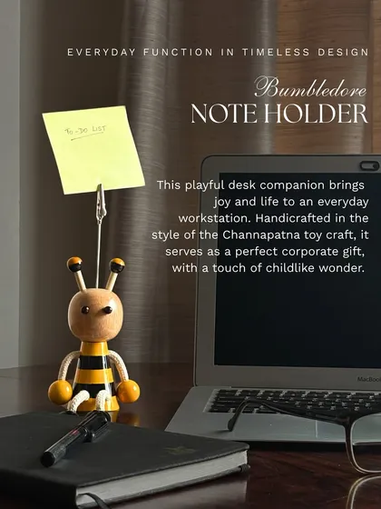 This is our Bumbledore note holder, a playful yet functional companion for any workstation. Handcrafted in the Channapatna style, it adds a touch of joy and childlike wonder to the corporate desk, making it a perfect gift for colleagues and clients.