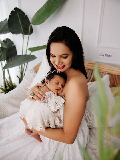 A tender moment between mother and child, set against a clean, bright backdrop. These portraits highlight the simple beauty of your connection.