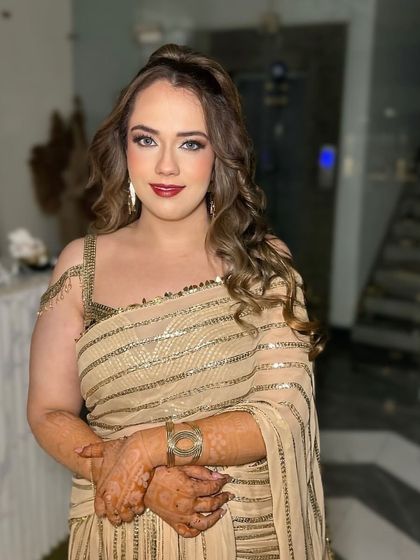 The perfect party-ready look. Her skin is glowing and the red lip makes a powerful statement.